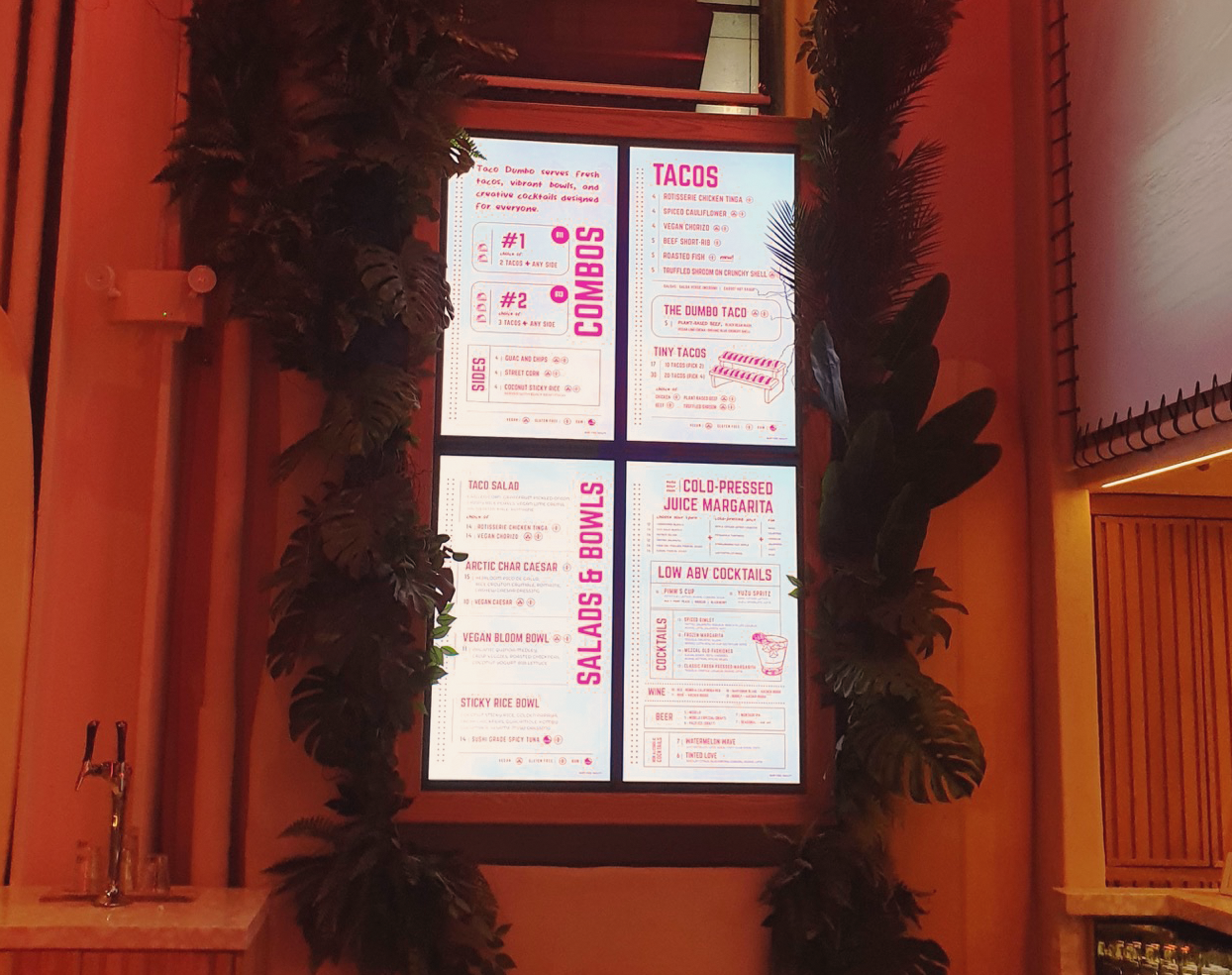 Four-panel digital menu board with tropical décor